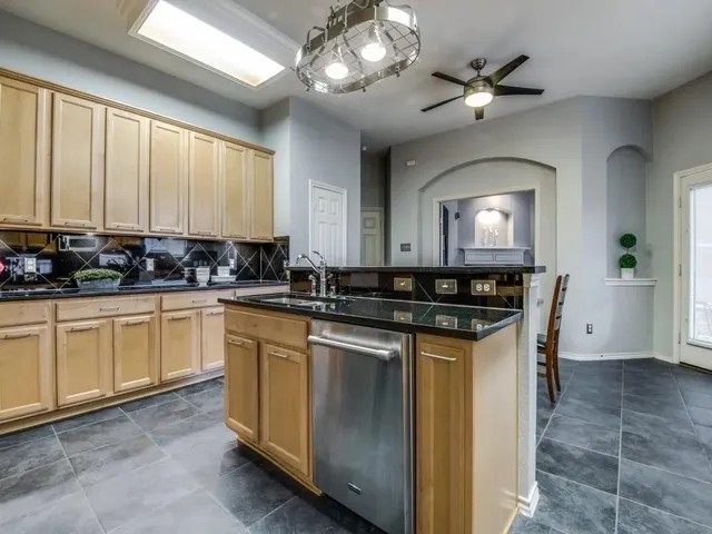 a kitchen with a sink cabinets and window