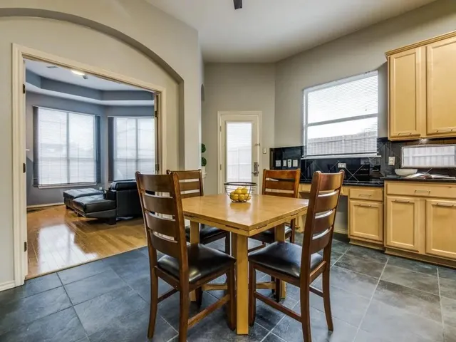 a view of a dining room with furniture and a window