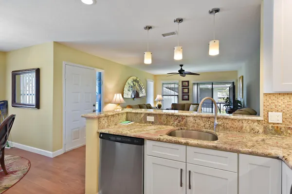 a kitchen with kitchen island granite countertop a table and chairs in it