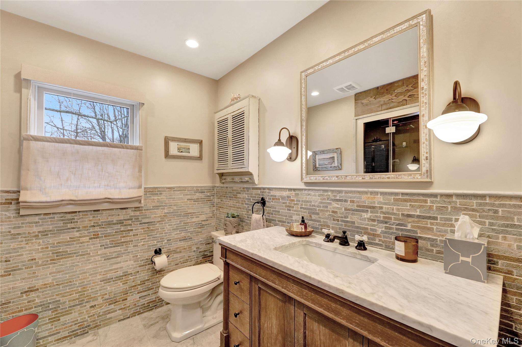 198 South Country Road Remsenburg, NY 11960 - Photo 34 of 49 a bathroom with a granite countertop toilet sink and mirror