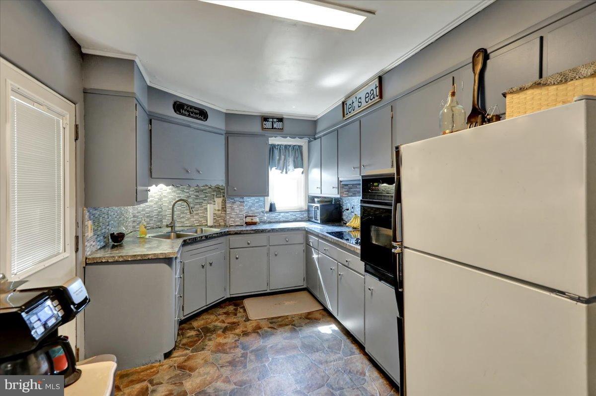 258 East Walnut Street Kutztown, PA 19530 - Photo 8 of 30 a kitchen with granite countertop a refrigerator and a sink
