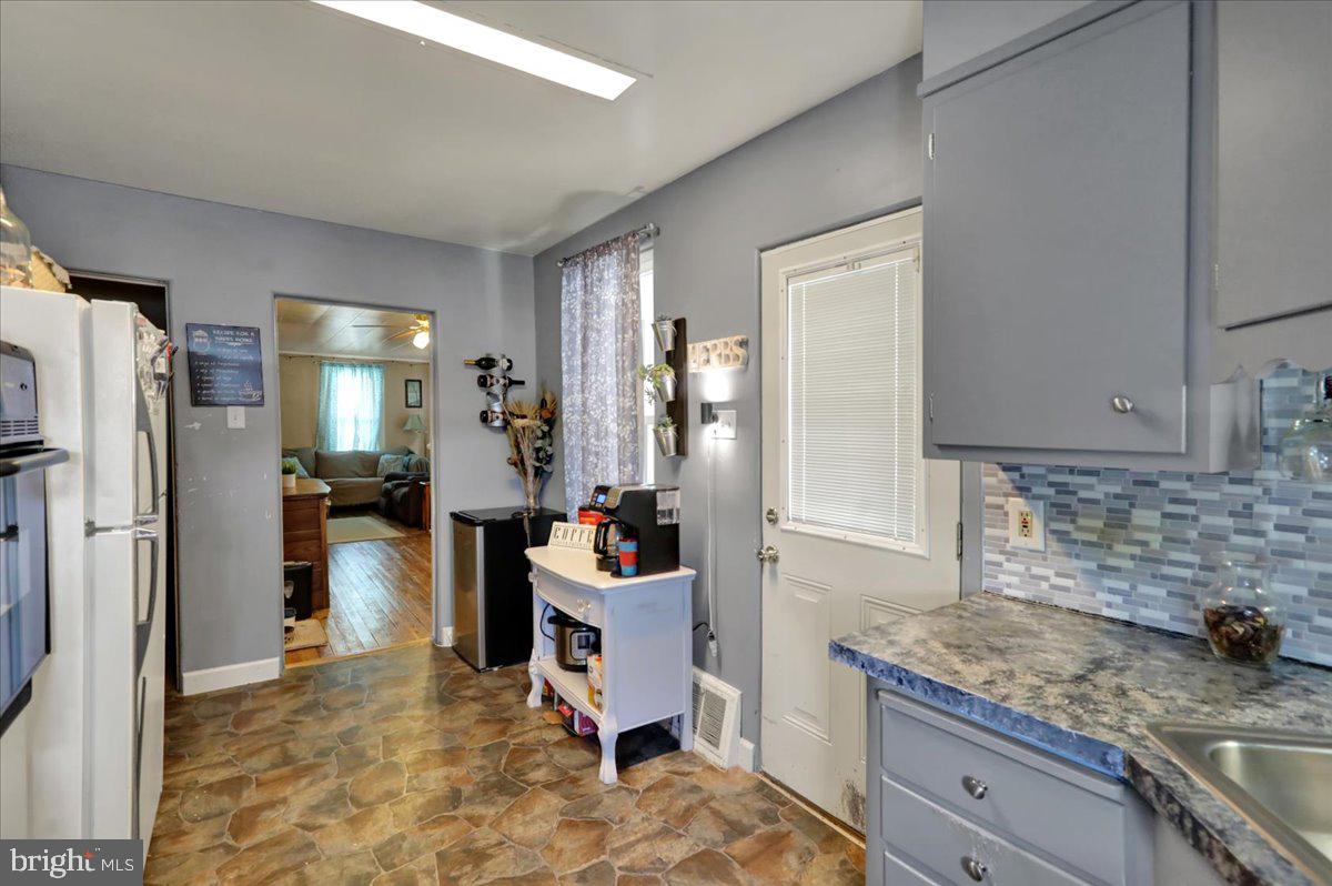 258 East Walnut Street Kutztown, PA 19530 - Photo 10 of 30 a kitchen with stainless steel appliances granite countertop a refrigerator and a sink