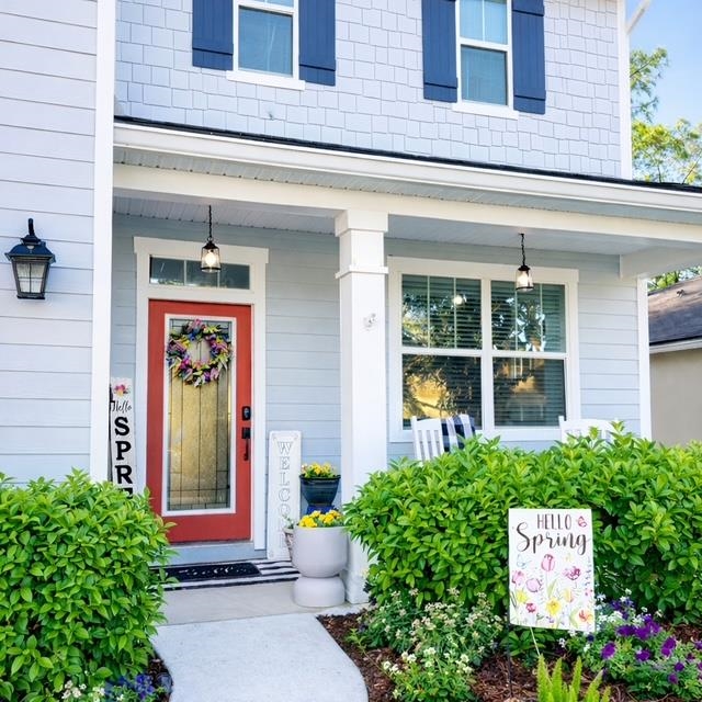 View of exterior entry featuring a porch