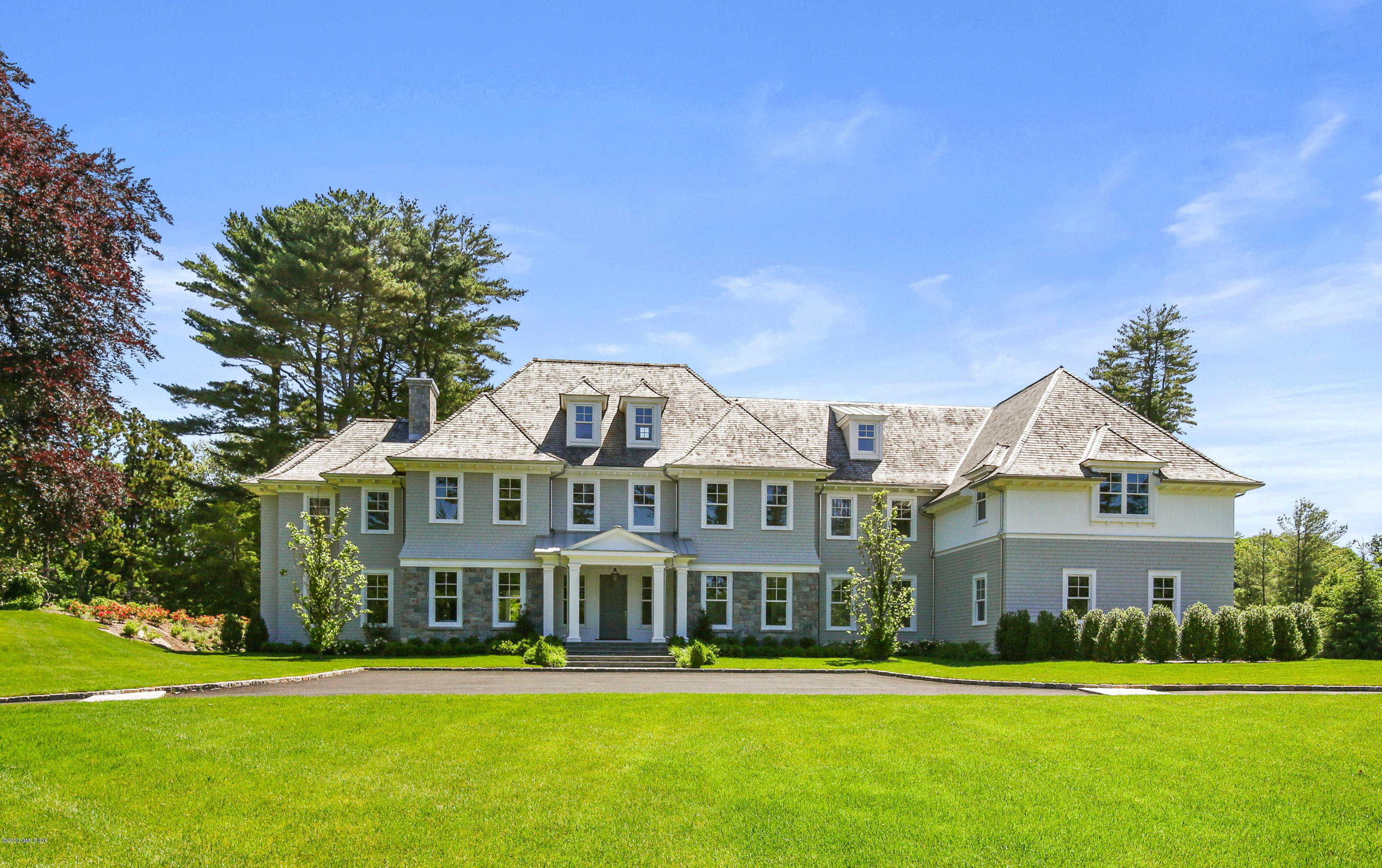 a front view of a building with trees in the background