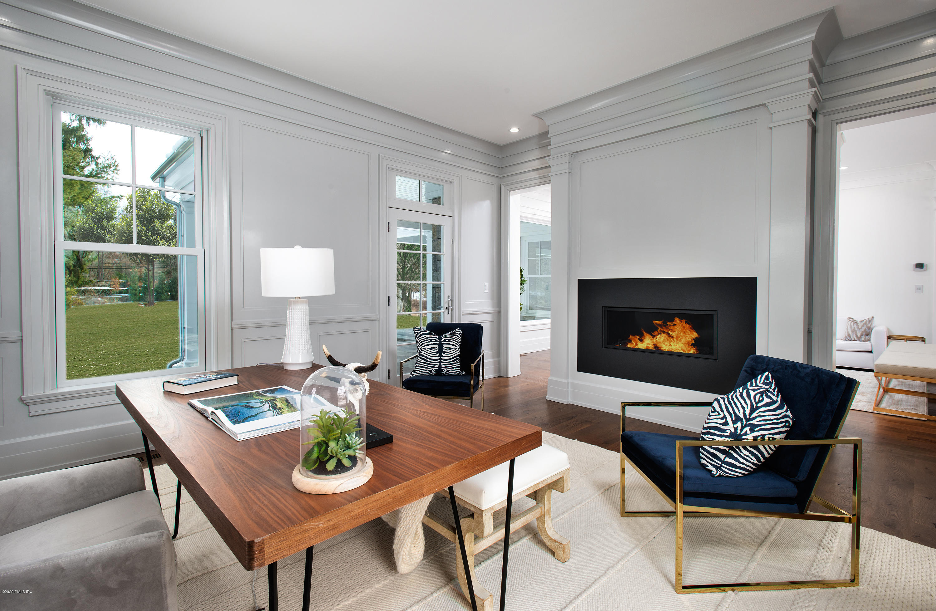 498 Lake Avenue Greenwich, CT 06830 - Photo 11 of 37 a living room with furniture a fireplace a flat screen tv and a large window
