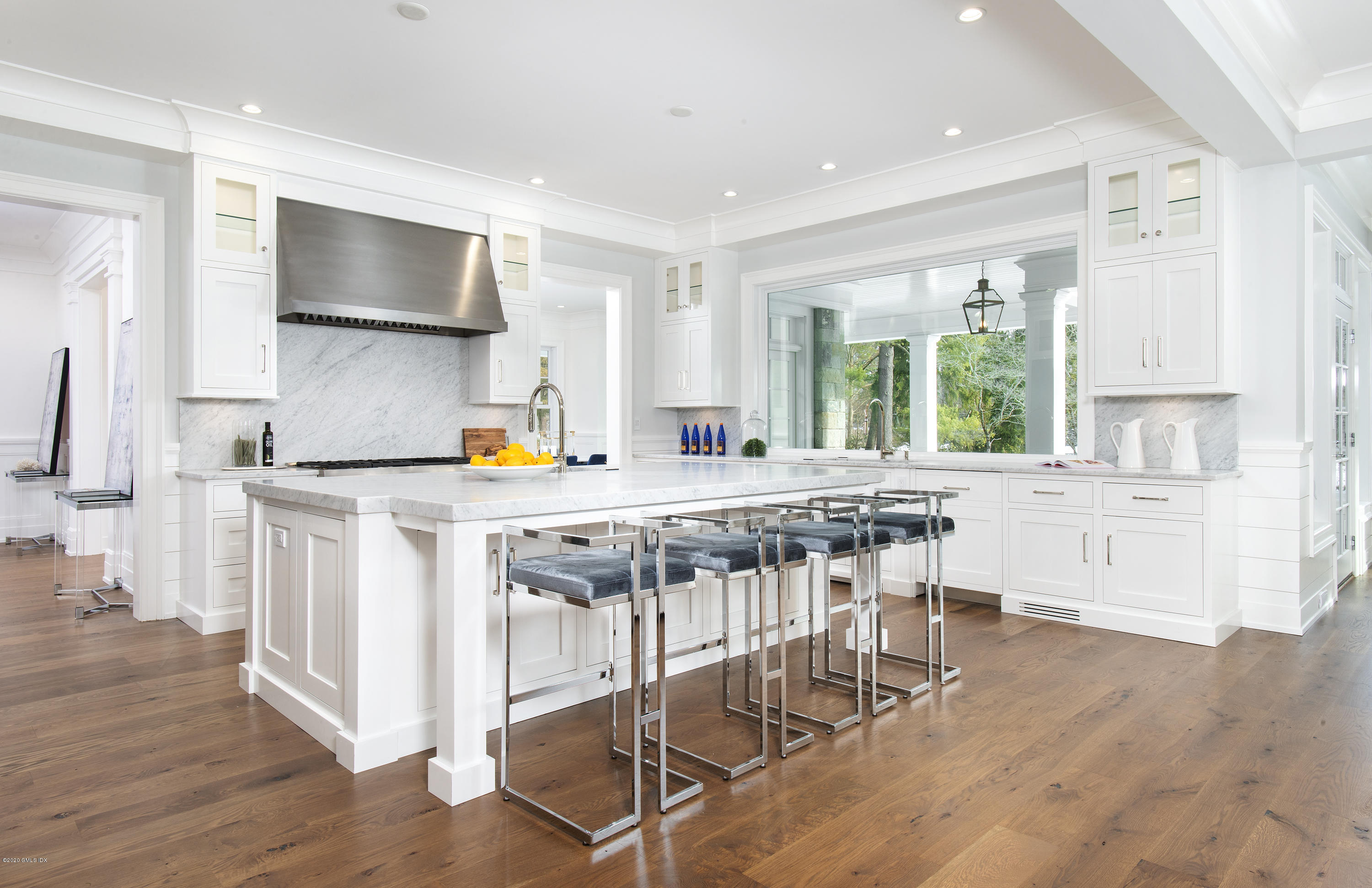 498 Lake Avenue Greenwich, CT 06830 - Photo 14 of 37 a kitchen with stainless steel appliances granite countertop a stove top oven a sink dishwasher and white cabinets with wooden floor