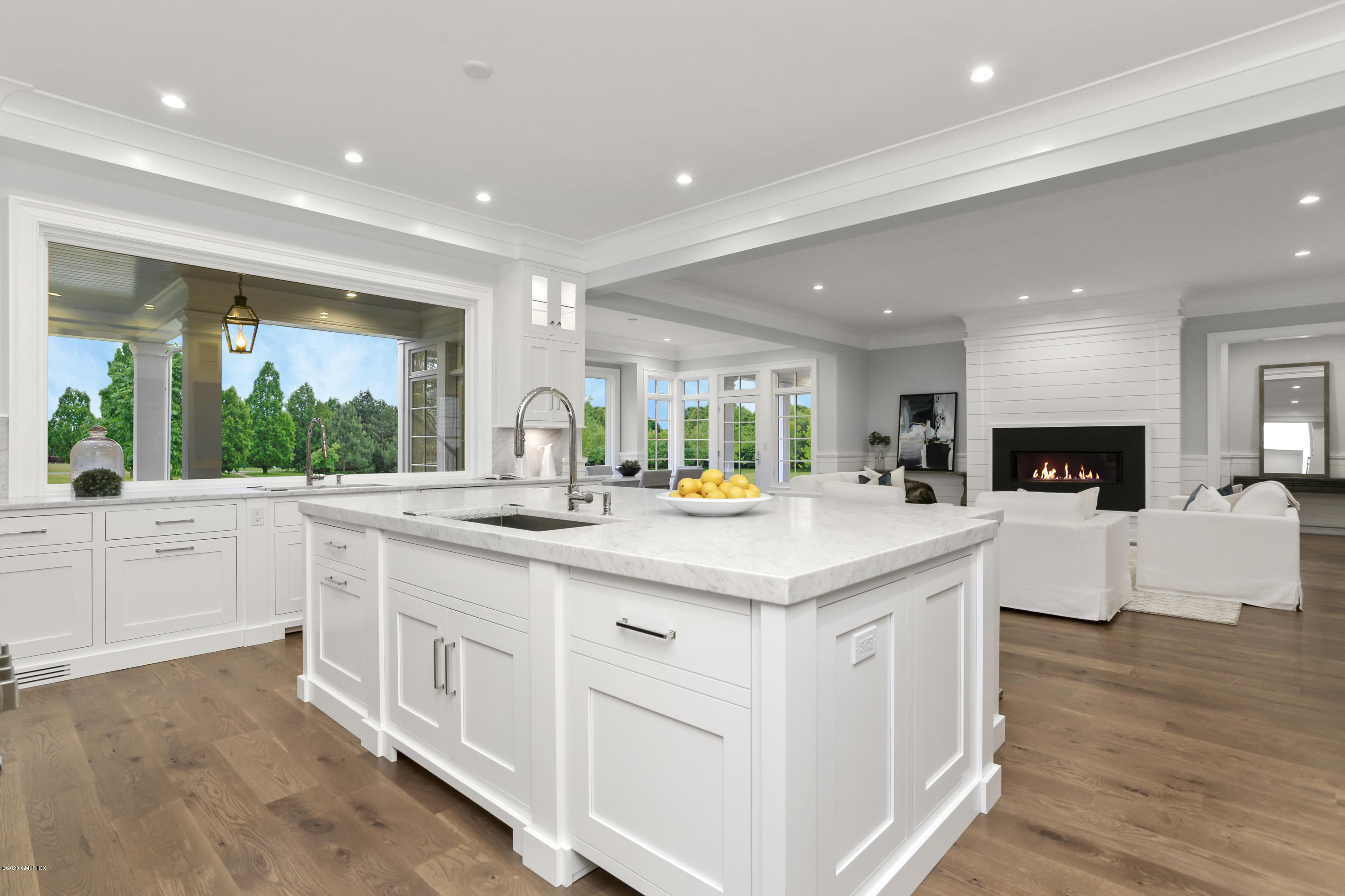 498 Lake Avenue Greenwich, CT 06830 - Photo 16 of 37 a kitchen with sink stove and white cabinets with wooden floor