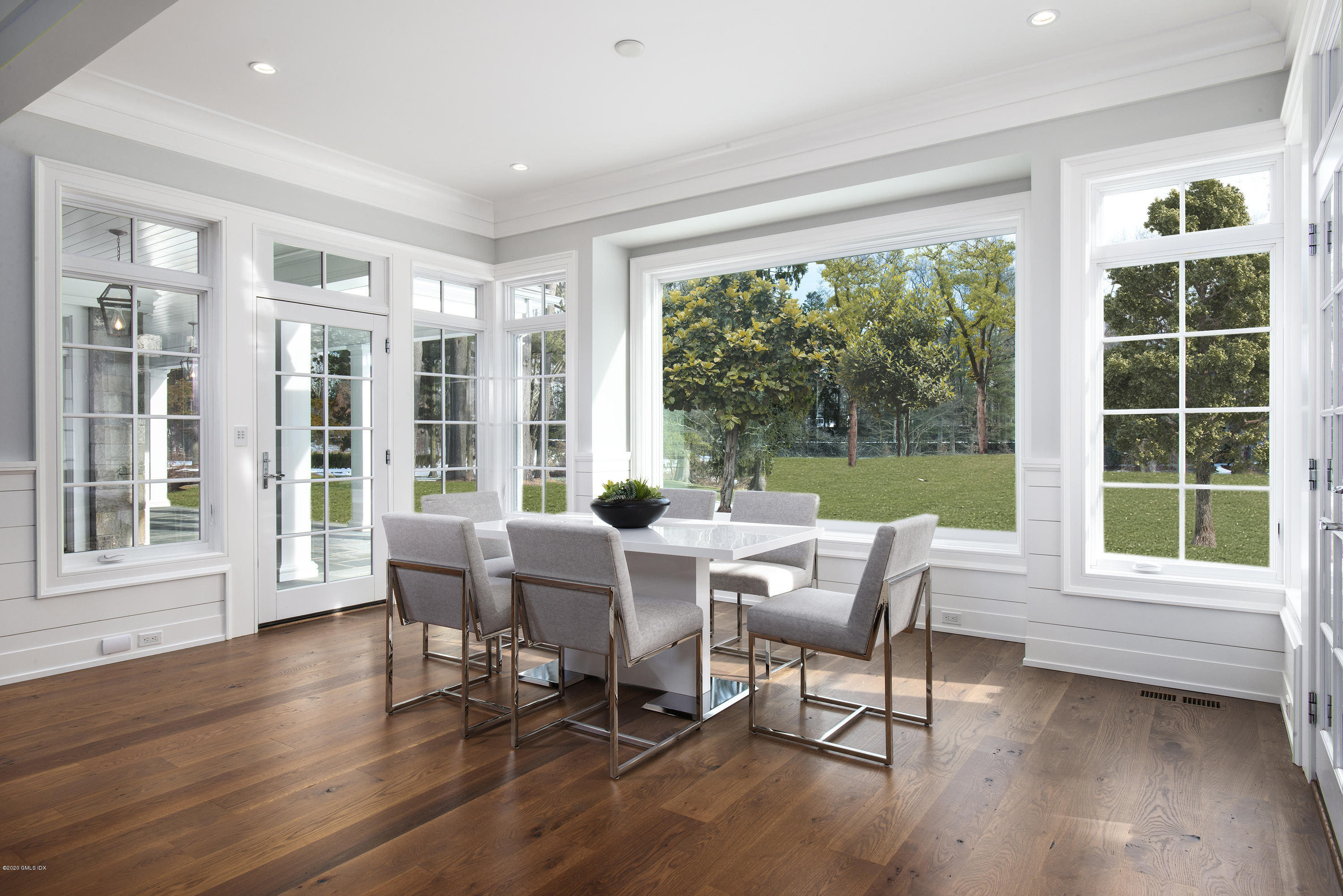 498 Lake Avenue Greenwich, CT 06830 - Photo 19 of 37 a dining room with wooden floor and windows