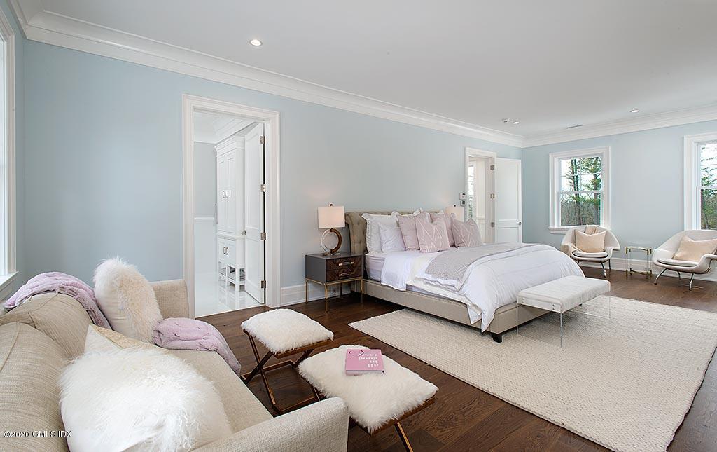 498 Lake Avenue Greenwich, CT 06830 - Photo 28 of 37 a spacious bedroom with a bed and wooden floor