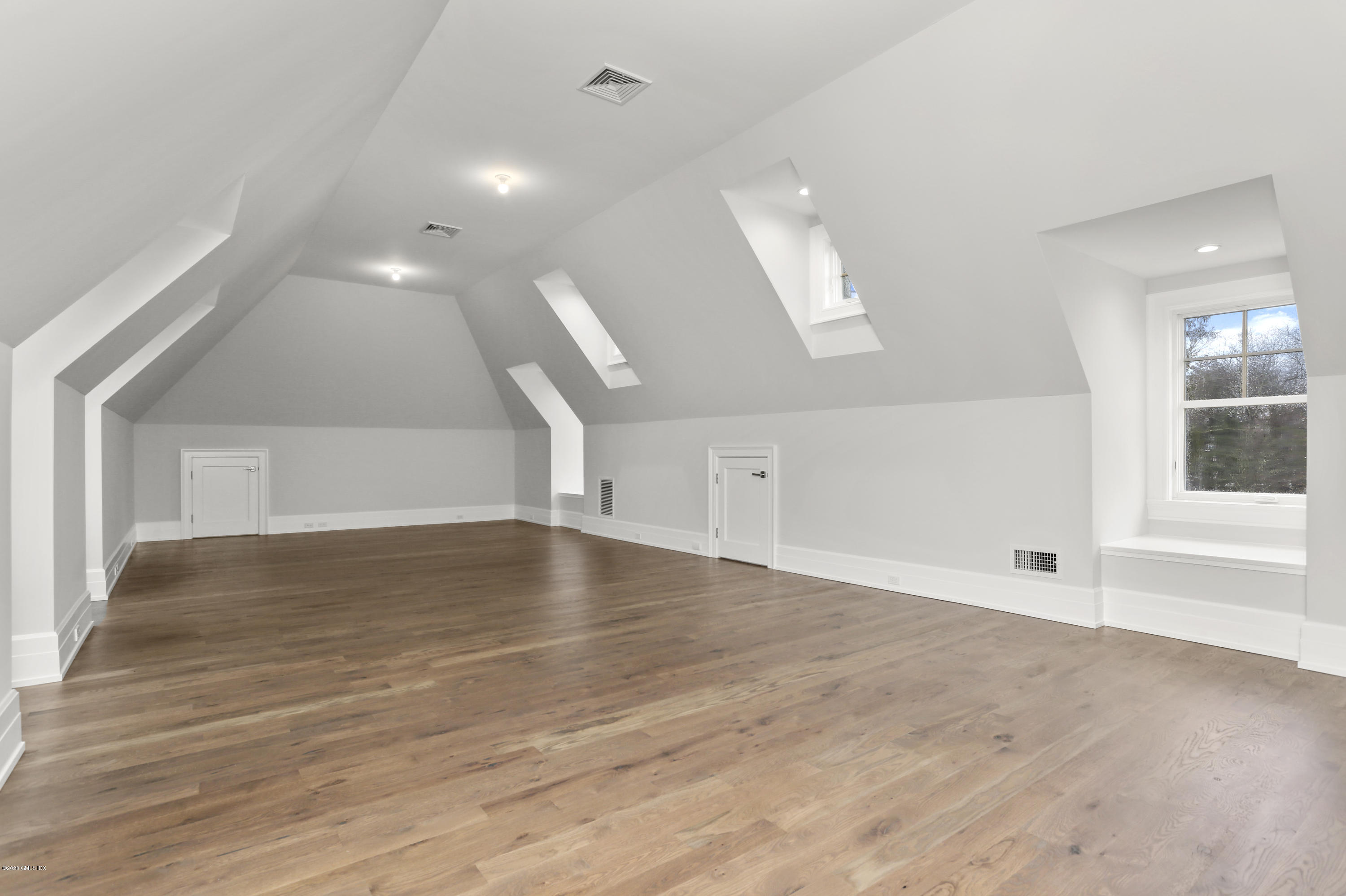 498 Lake Avenue Greenwich, CT 06830 - Photo 33 of 37 an empty room with wooden floor and windows