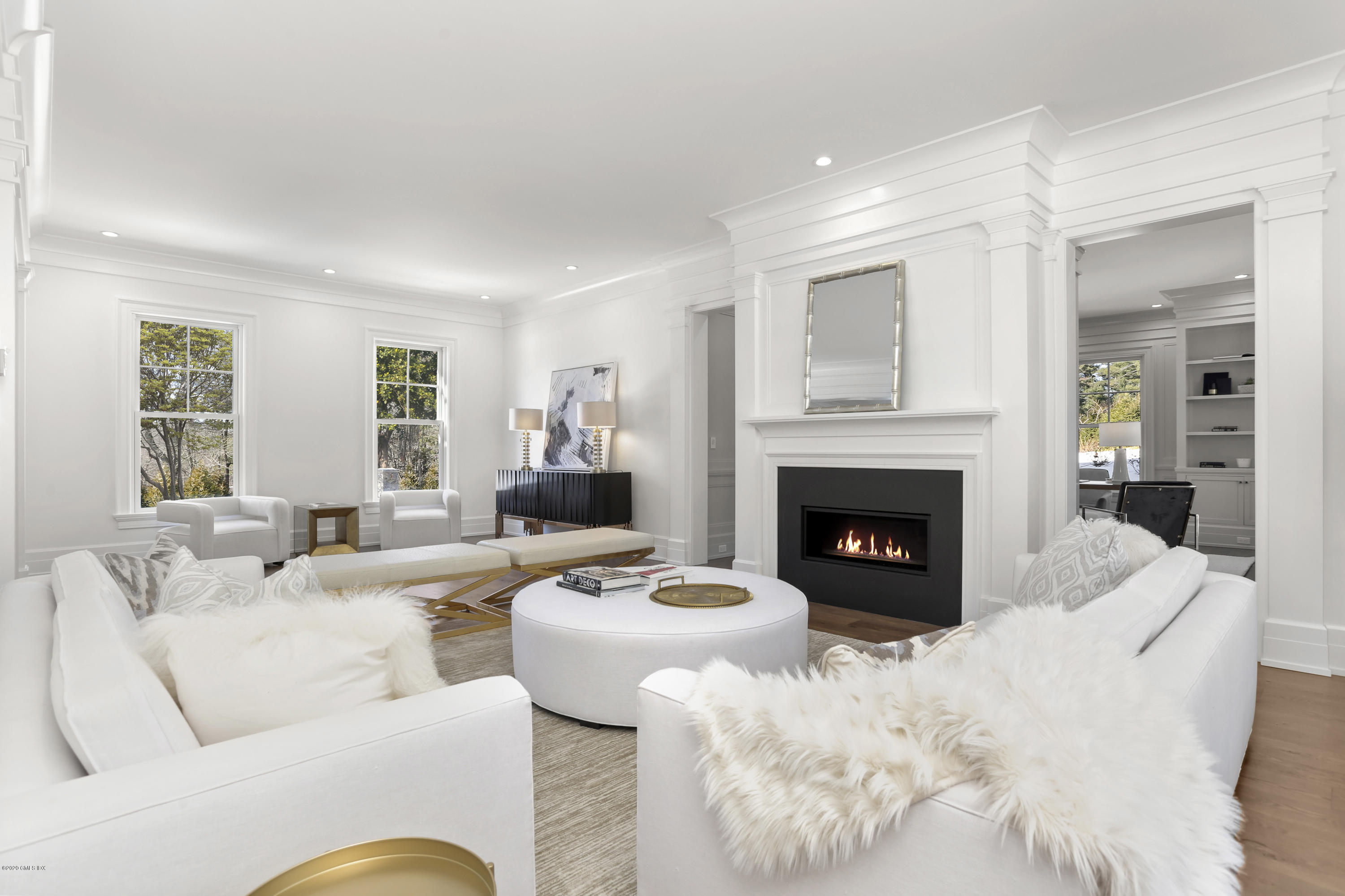 498 Lake Avenue Greenwich, CT 06830 - Photo 10 of 37 a living room with furniture a large window and a fireplace