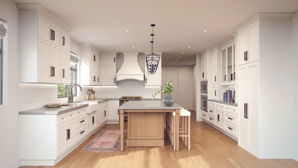 a large white kitchen with cabinets and wooden floor