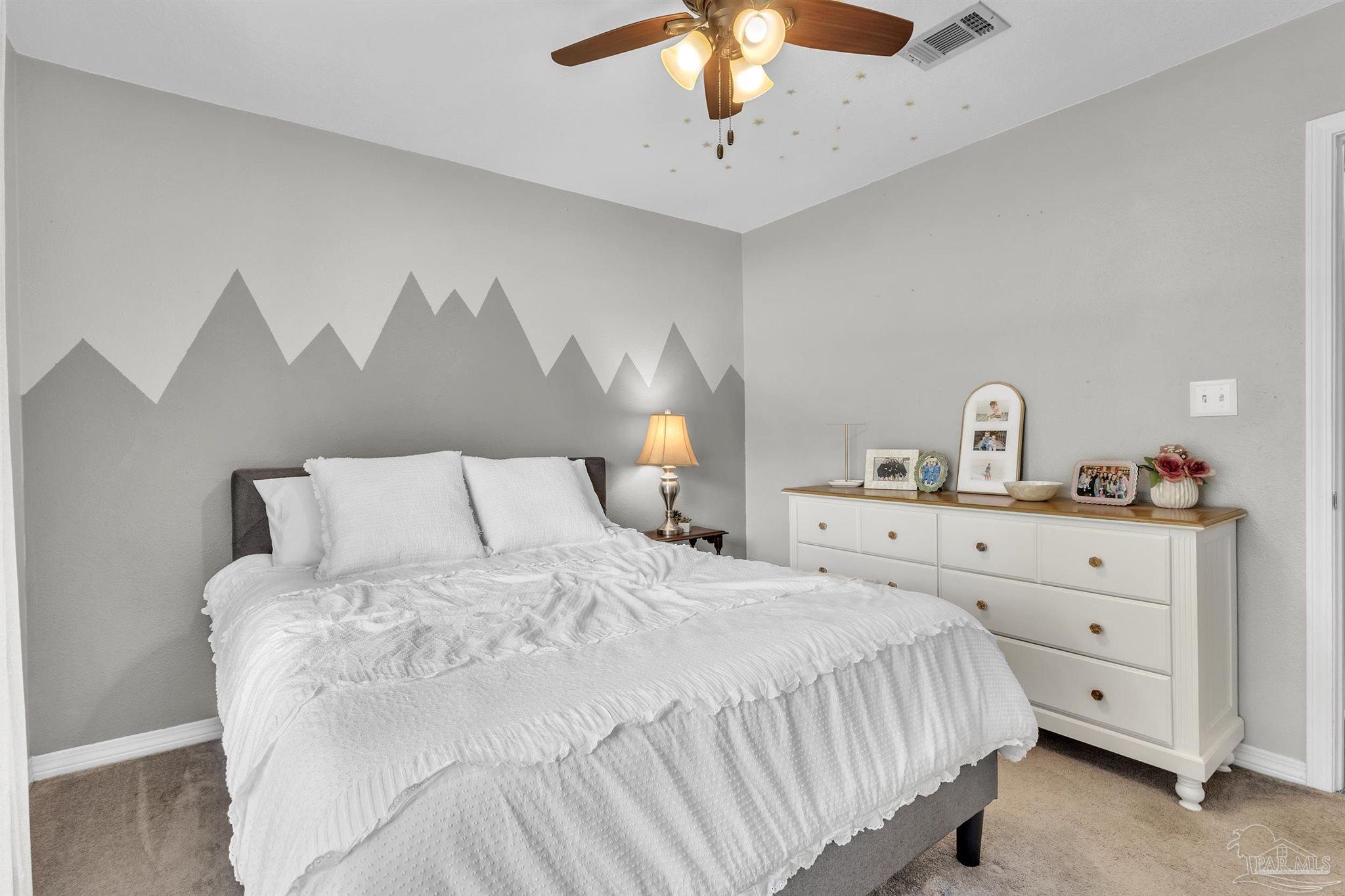 4321 Ridgeland Drive Pace, FL 32571 - Photo 20 of 36 a bedroom with a bed and a chandelier