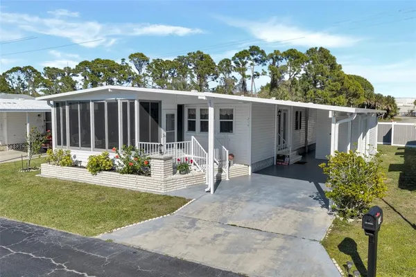 a view of a house with backyard and porch