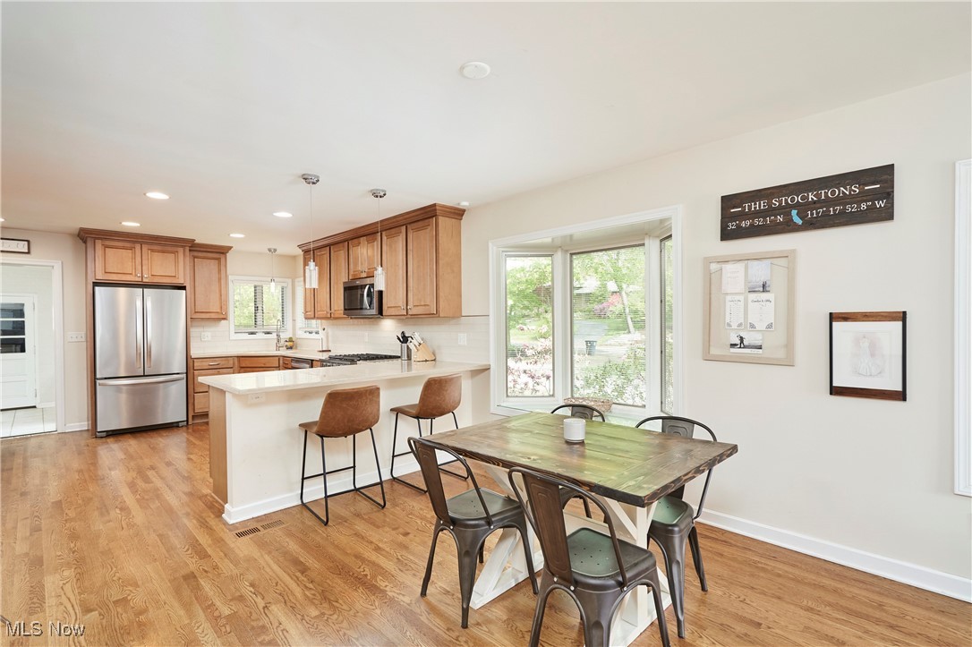 2530 Holgate Road Akron, OH 44313 - Photo 11 of 31 Kitchen with appliances with stainless steel finishes, a peninsula, light countertops, light wood finished floors, and baseboards