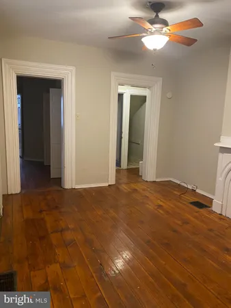 a view of empty room with window and ceiling fan