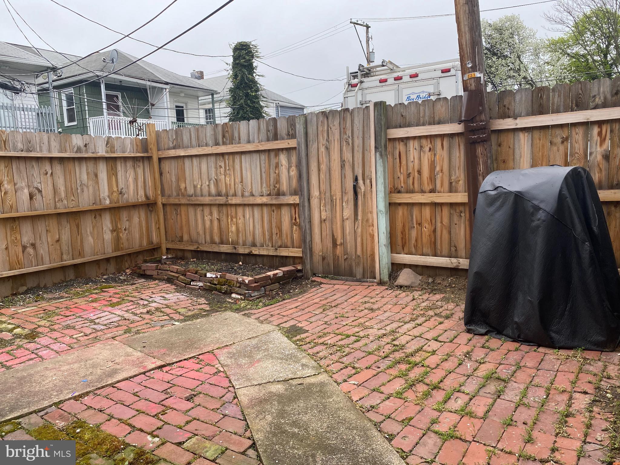 260 Verbeke Street Harrisburg, PA 17102 - Photo 10 of 20 Charming brick patio with wooden fencing.
