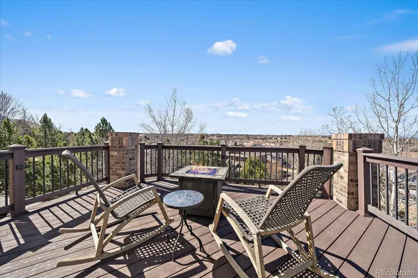 a view of a balcony with wooden chairs