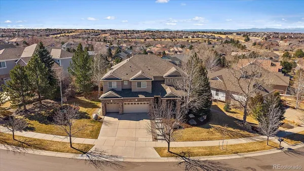 an aerial view of a house with a yard
