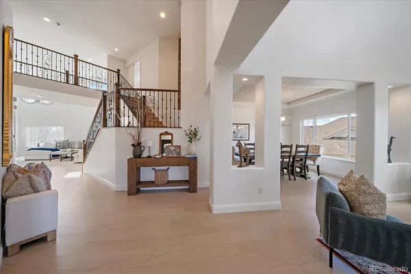 a living room with furniture and a fireplace with wooden floor