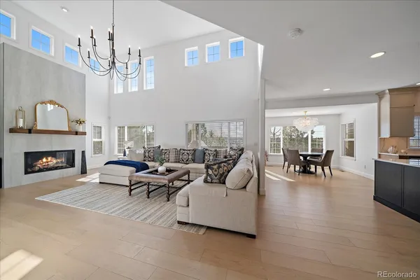 a kitchen with stainless steel appliances kitchen island granite countertop a table chairs sink and cabinets