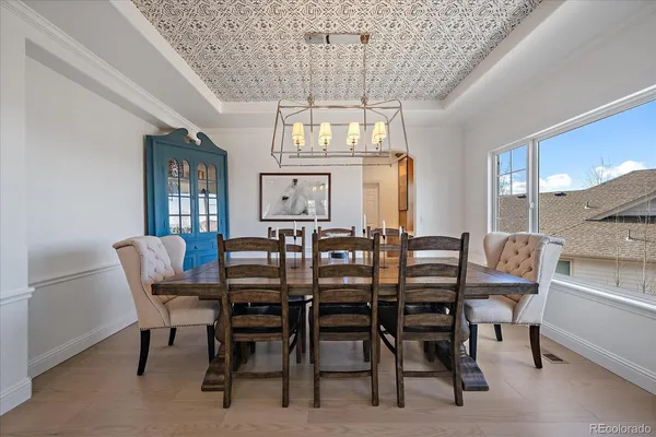 a view of a dining room with furniture large windows and wooden floor