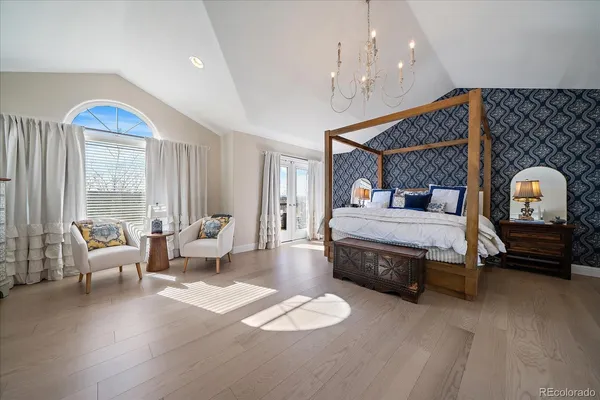 a large kitchen with kitchen island granite countertop a stove and white cabinets