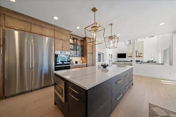 a kitchen with stainless steel appliances granite countertop a sink and refrigerator