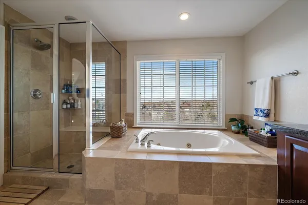 a spacious bedroom with a bed and a flat screen tv