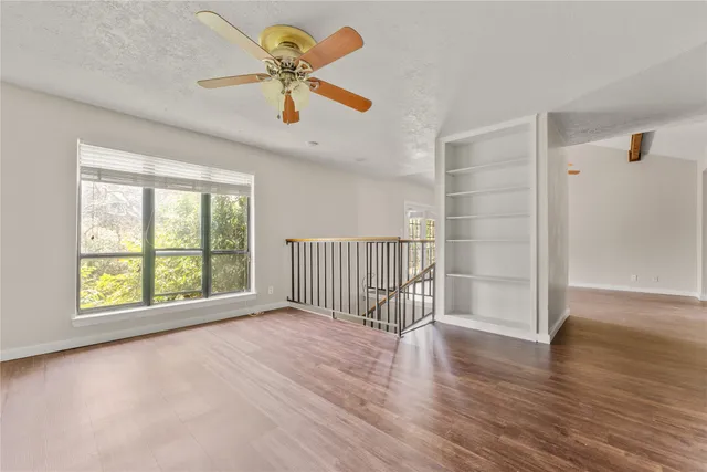 wooden floor in an empty room with a window