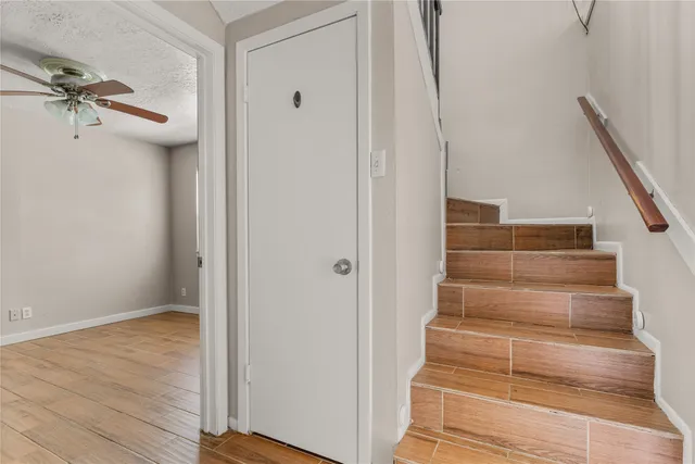 a view of a hallway with wooden floor and entryway