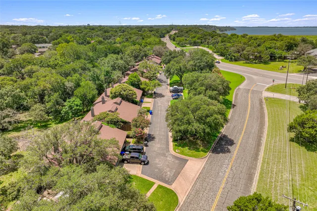 an aerial view of a house with a yard and lake view