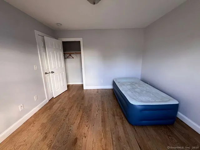 a room with wooden floor and window