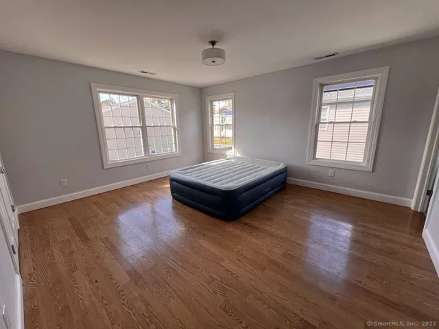 a living room with hard wood floors and a window