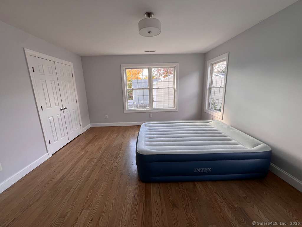 793 Pond Street Bridgeport, CT 06606 - Photo 13 of 28 a bedroom with a bed and wooden floor