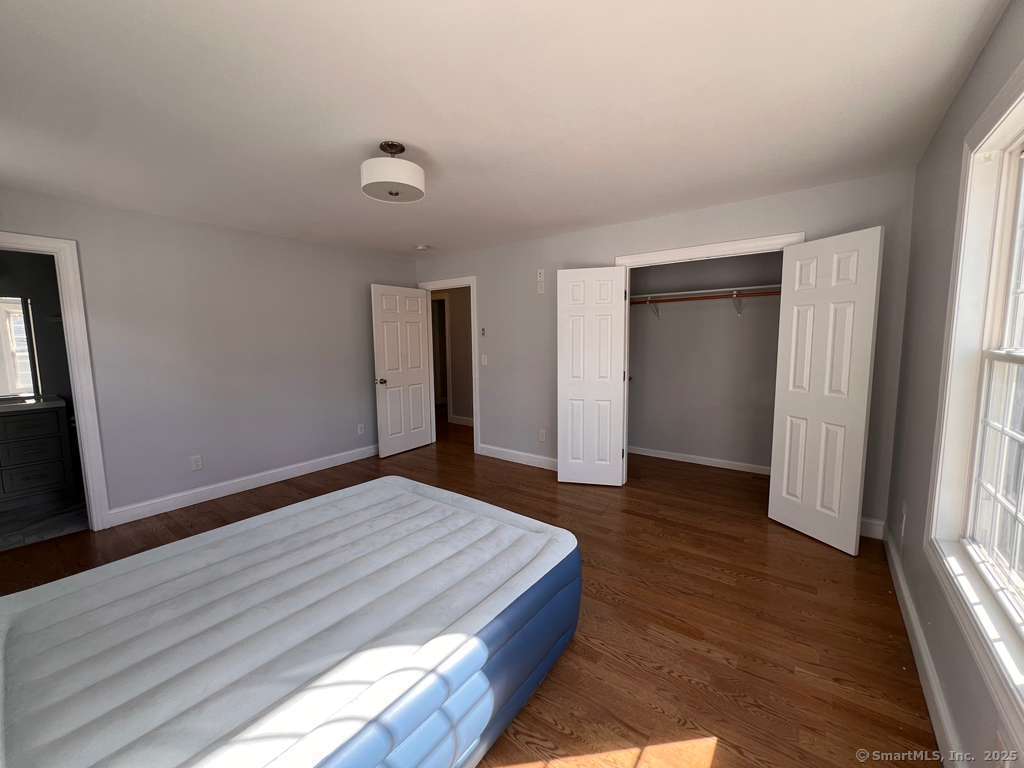 793 Pond Street Bridgeport, CT 06606 - Photo 17 of 28 a bedroom with a bed and a window