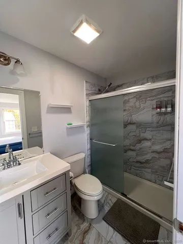 a bathroom with a toilet a sink and shower