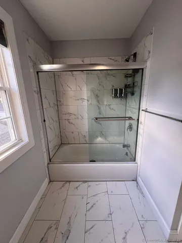 a bathroom with a bathtub and a shower