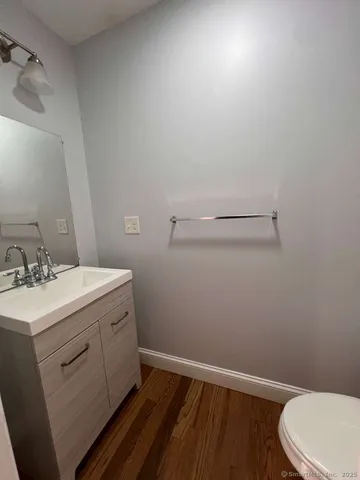 a bathroom with a sink toilet and vanity