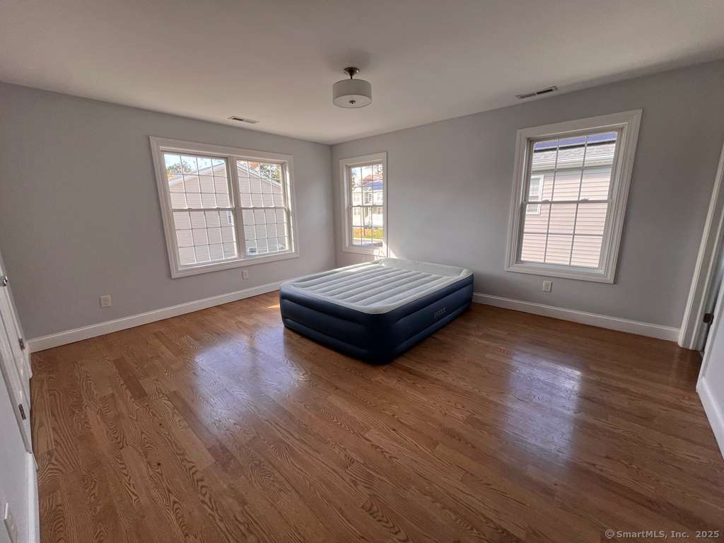 793 Pond Street Bridgeport, CT 06606 - Photo 20 of 28 a living room with hard wood floors and a window