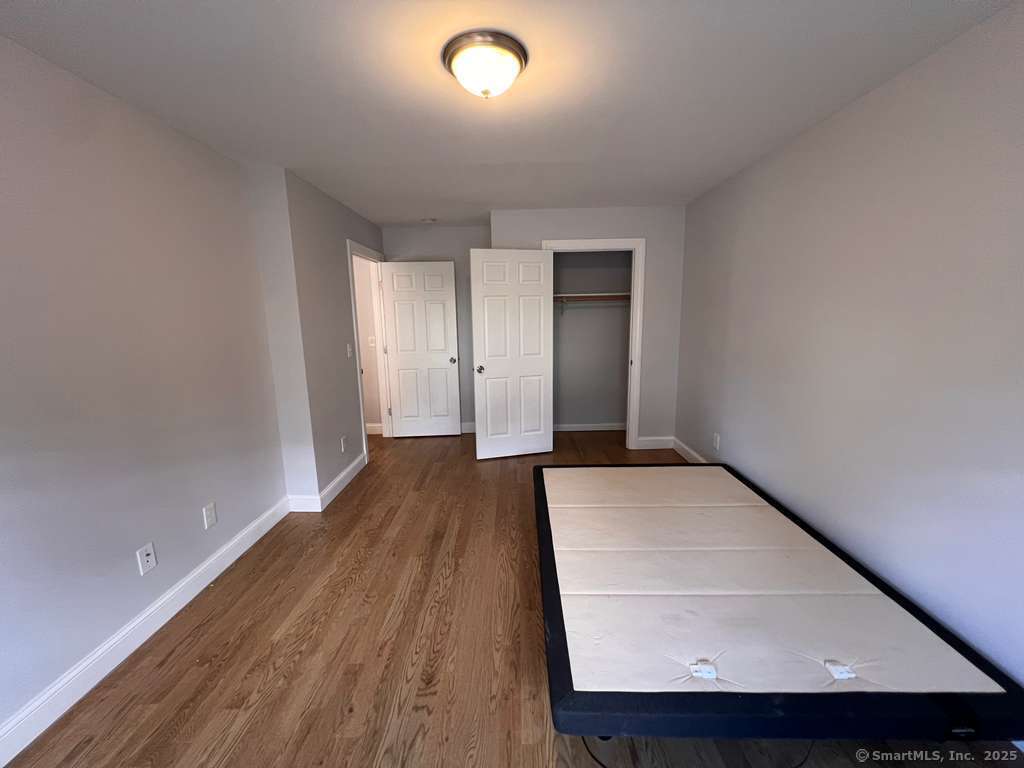 793 Pond Street Bridgeport, CT 06606 - Photo 23 of 28 wooden floor in a hall with an entryway