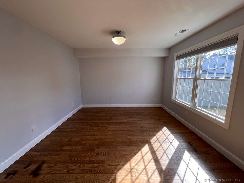 793 Pond Street Bridgeport, CT 06606 - Photo 25 of 28 a view of empty room with wooden floor and fan
