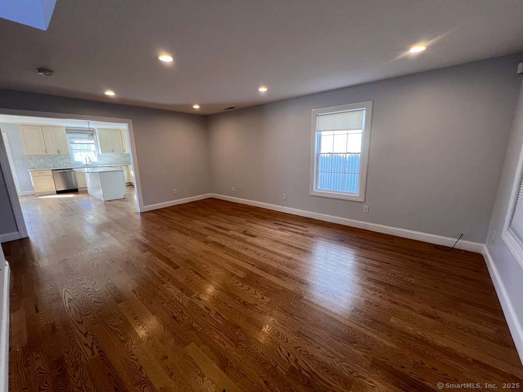 793 Pond Street Bridgeport, CT 06606 - Photo 26 of 28 an empty room with wooden floor and windows