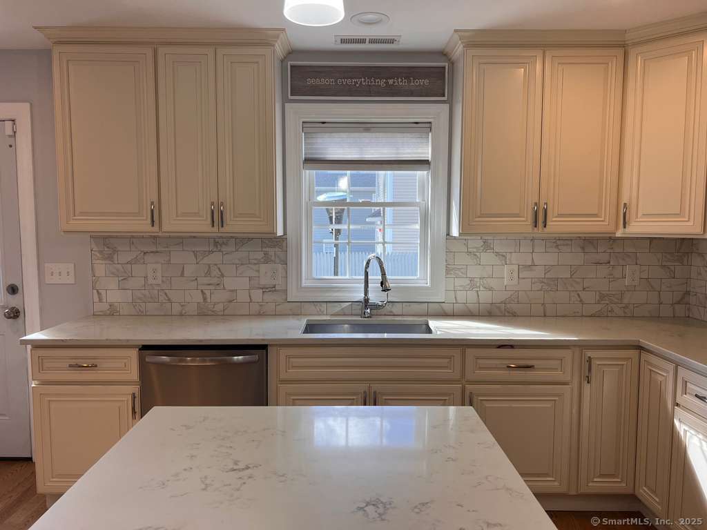 793 Pond Street Bridgeport, CT 06606 - Photo 5 of 28 a kitchen with sink cabinets and window