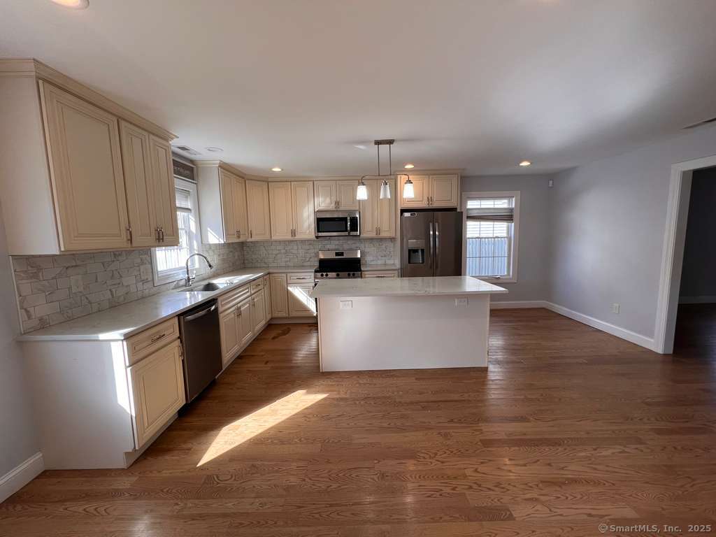 793 Pond Street Bridgeport, CT 06606 - Photo 6 of 28 a large kitchen with stainless steel appliances granite countertop a lot of counter space and wooden floor
