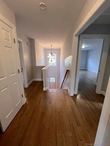 a view of a room with wooden floor and staircase