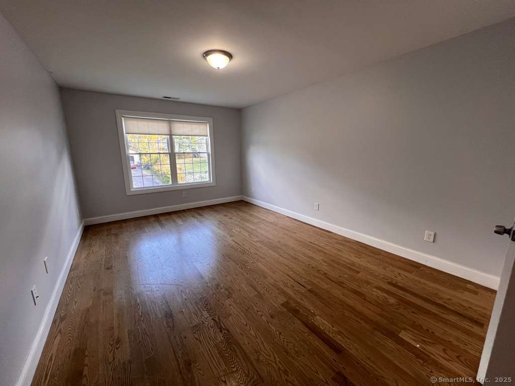 793 Pond Street Bridgeport, CT 06606 - Photo 9 of 28 wooden floor in an empty room with a window