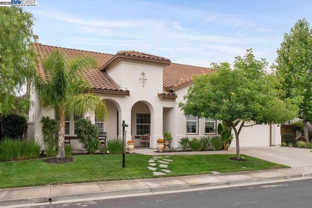 a front view of a house with a garden