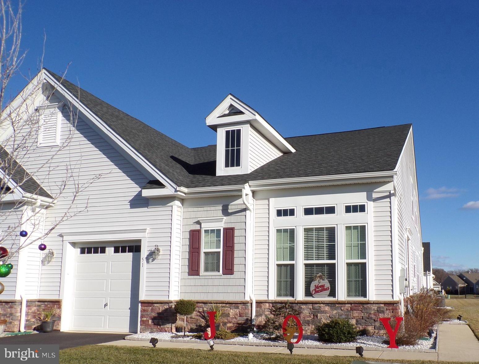 a front view of a house with cars