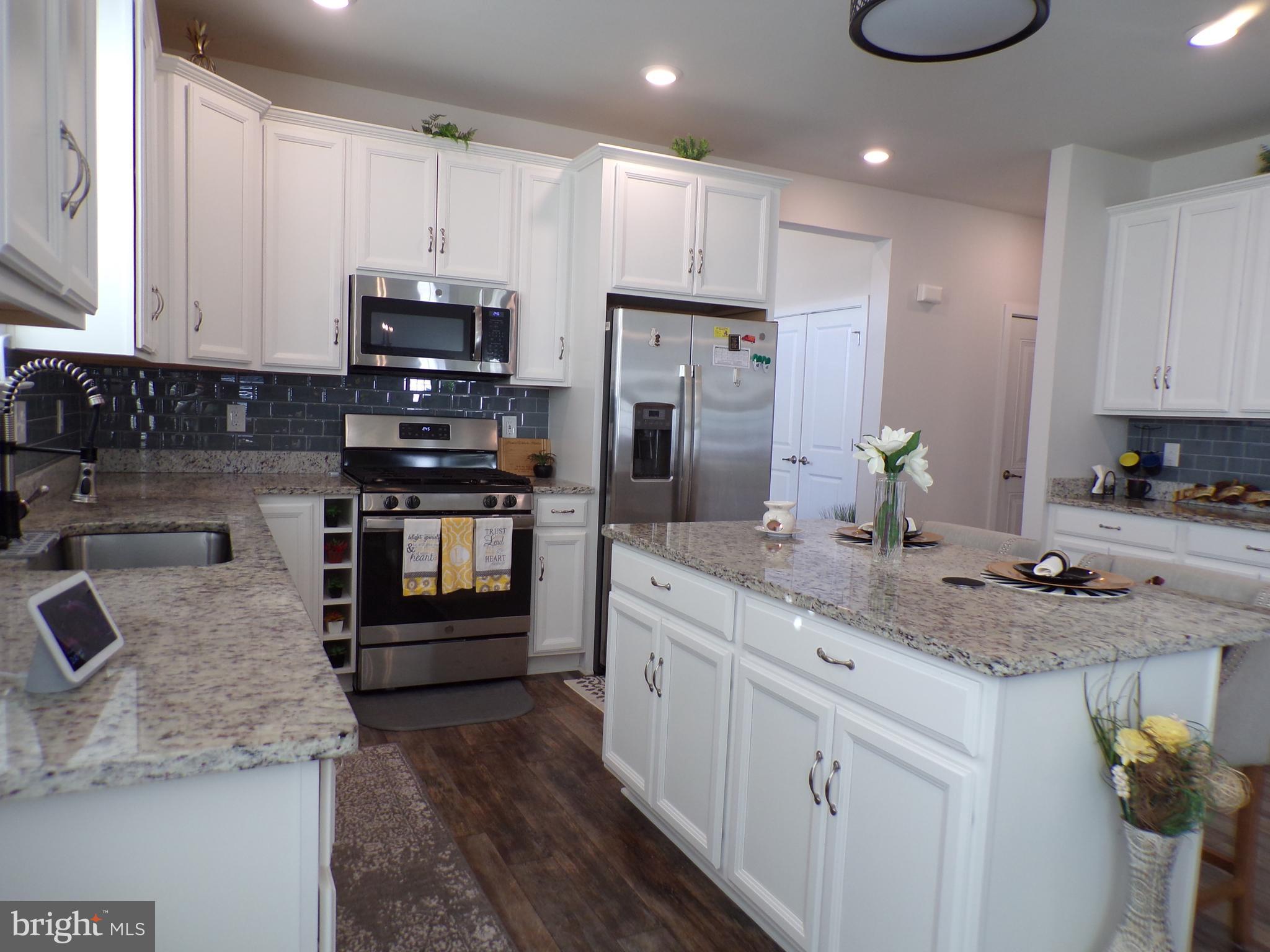 51 Bridge Boulevard Mount Holly, NJ 08060 - Photo 11 of 74 a kitchen with stainless steel appliances granite countertop a sink stove and refrigerator